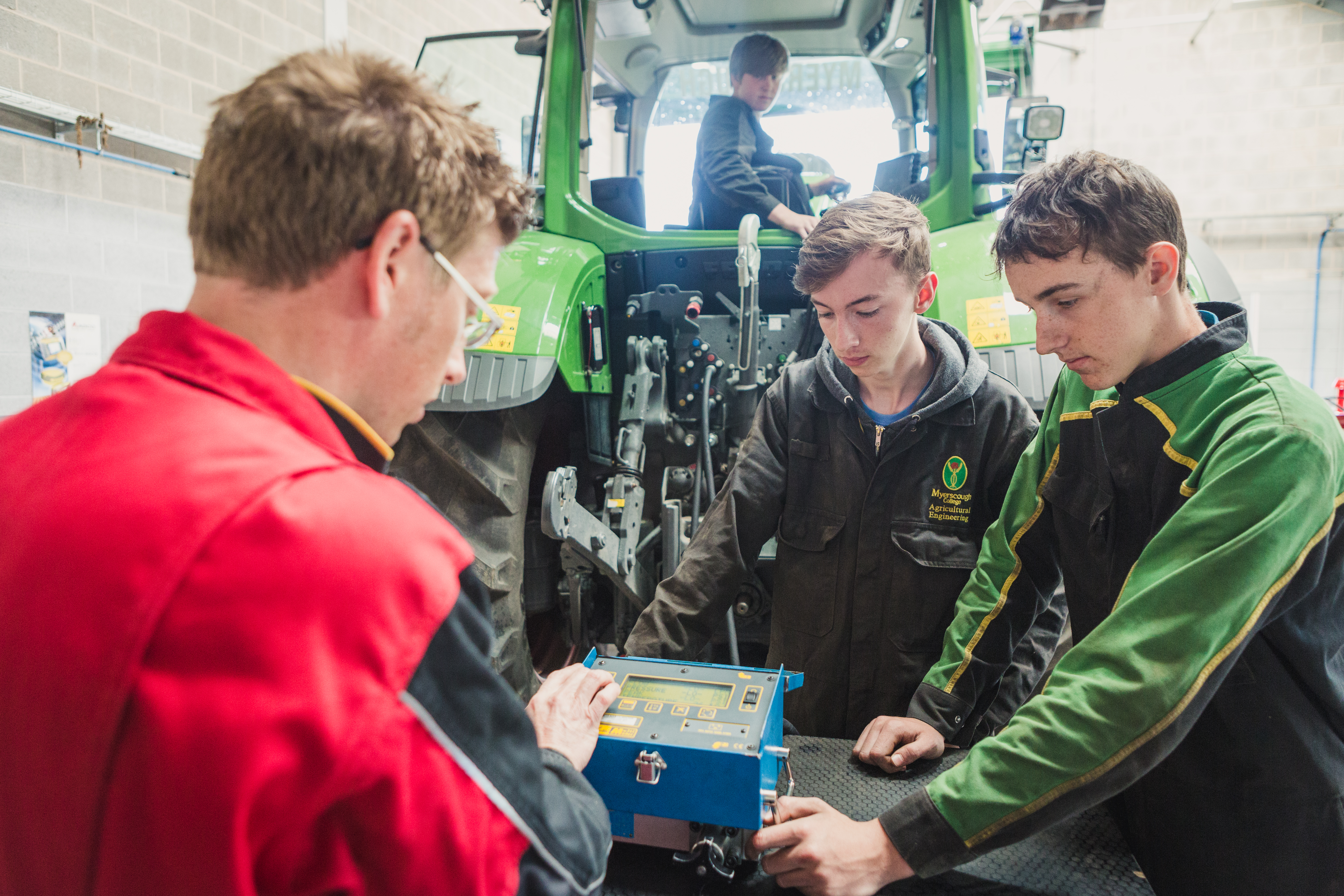 A Myerscough Agricultural Engineering tutor supervising a practical session