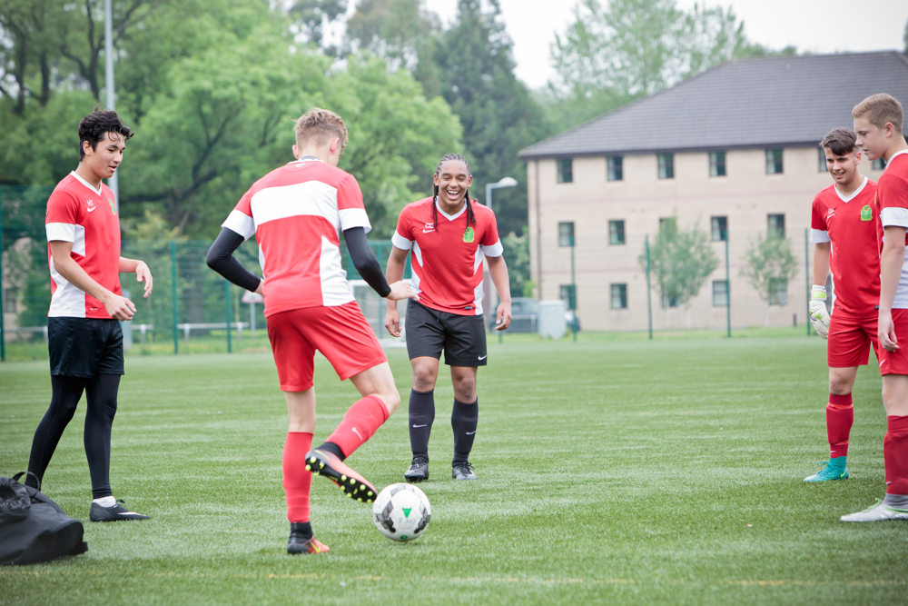 Five Myerscough College students playing football on a 3G pitch